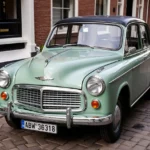A vintage Dutch car parked on a cobblestone street.