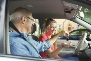 dziadek przekazuje wnuczce kluczyki do auta