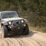 black and white jeep wrangler on dirt road during daytime